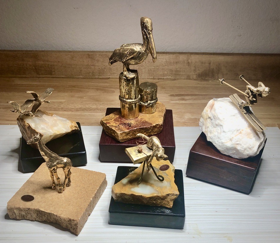 24K gold plated pewter sculptures represnting series by sculptor Jess Nelson: Wildlife Series, Aquatic Series, Sports Series and Whimsical Series all on Onyx